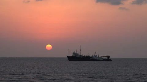 Boat floating at tropical sunset in the open sea. Weapon smuggler ship - Sudan Stock Footage 61083427