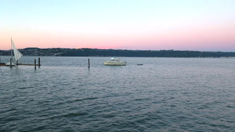Boat floating on the water at sunset 動画素材 203963351
