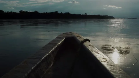 A boat floats down the Rio Napo, Ecuador, next to the Yasuni National Park. Video stock 265696667