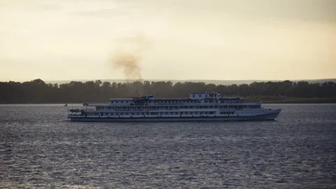 Boat floats down the river on a sunset background. Stock Footage 91052666