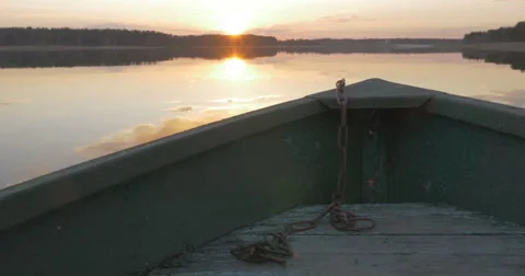 Boat floats on the lake at sunset Stock Footage 64845142
