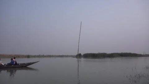 A boat floats on the river Ganges that flows through the village Video stock 248713497