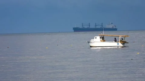Boat in Front of Tanker Stock Footage 135990558