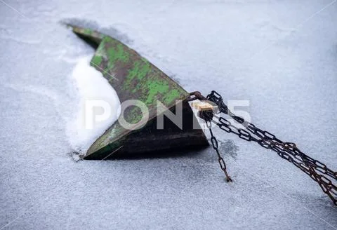 Boat frozen in cold ice at winter Stock Photos