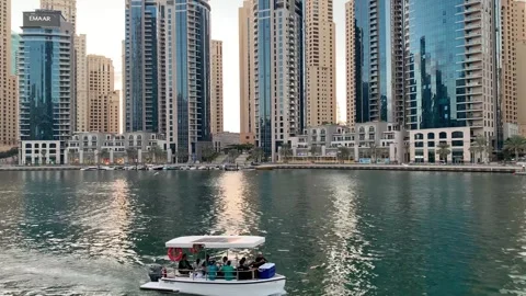 Boat full of people sails through Dubai Marina Canal. Dubai, UAE Stock Footage 302883690