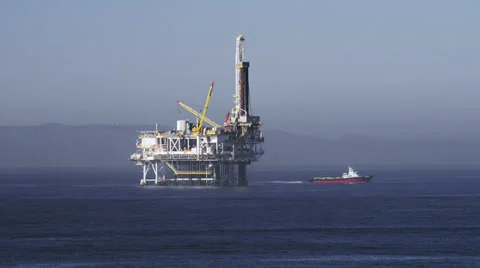 Boat getting away from oil platform in California Stock Footage 36125865