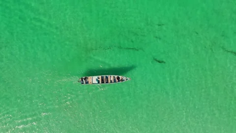Boat glides over clear turquoise water from above. Stock Footage 322019815