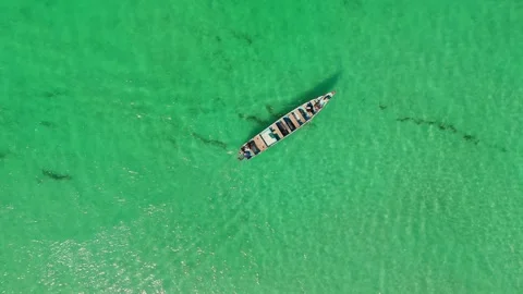 Boat glides over clear turquoise water from above. Stock Footage 322019825