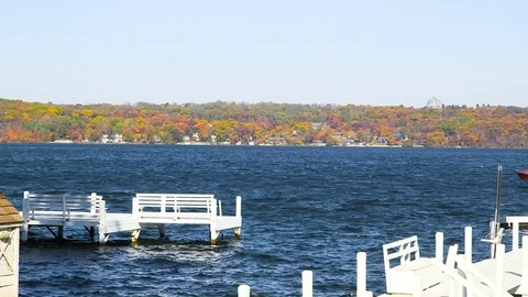 Boat goes by Pier in the Fall Stock Footage 115277973