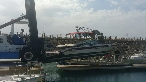 Boat going down from boat forklift to the sea at Herzliya Shipyard Stock Footage 101770917