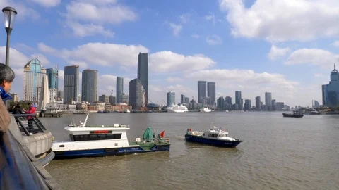 Boat going down Huangpu river by the Bund on a Clear Day Stock Footage 121195978
