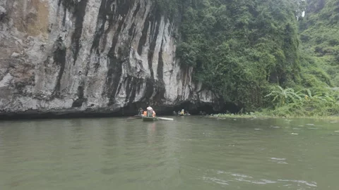 Boat going into limestone cave at Tam Coc Stock Footage 291208436