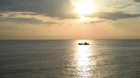 Boat going on open sea in front of sunset in Rovinj Croatia Stock-Footage 76800073