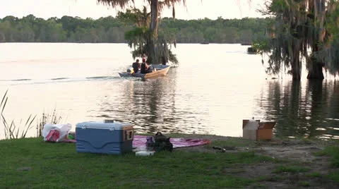 Boat going out to fish, picnic in foreground Видео 22917870