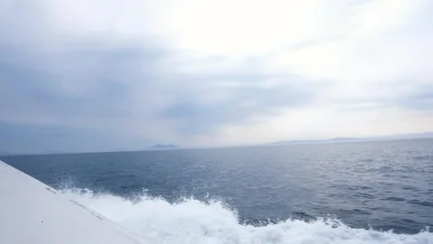 Boat going through Nemuro Straits, Kunashiri Island in the distance Stock Footage 328485247