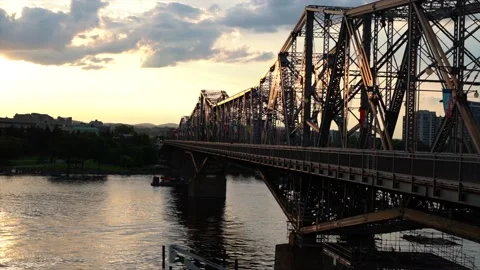 Boat going under the bridge during sunet Stock Footage 136980163
