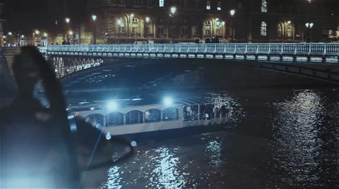 The boat going under the bridge ot the Remblai Seine in Paris at night Stock Footage 64189488
