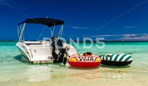 Boat in green water on Mauritius beach, postcard motive Stock Photos