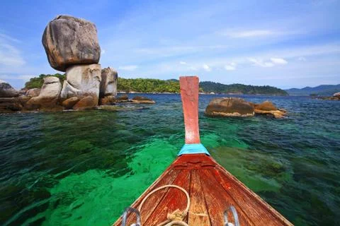 Boat heading to large stack stone arch Stock Photos