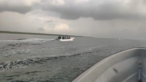 The boat is heading for a thunderstorm Stock Footage 156085708