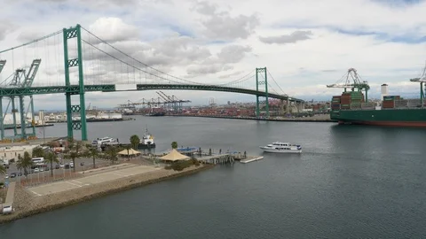 Boat heads to dock Vincent Thomas Bridge San Pedro CA in background Video stock 106879191