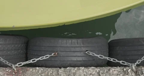 Boat Hull Impacting Rubber Tire Fenders on Pier Stock-Footage 336721796