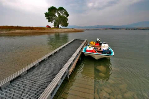 Boat at Lake Dock Stock Photos
