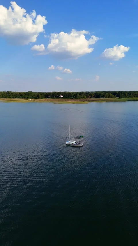 Boat On The Lake Flyback Shot By Drone Vertical Video Stock Footage 288089353