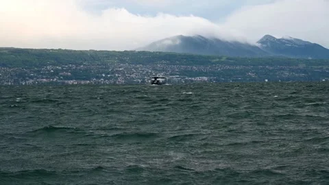 Boat on Lake Geneva with Dramatic Waves and Swiss Shoreline in Switzerland. Stock Footage 336435584
