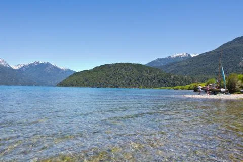 Boat at the lake side with mountain range in the background close to El Bol.. Stock Photos