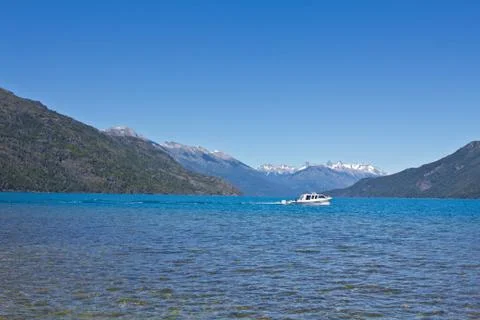 Boat at the lake side with mountain range in the background close to El Bol.. Stock Photos