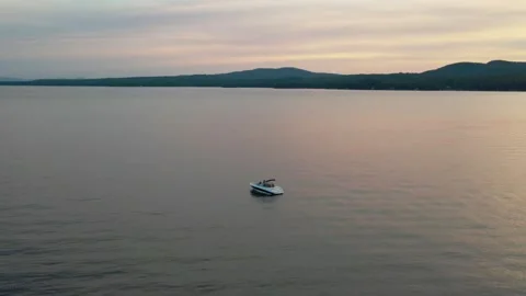 Boat on a lake at sunset Video stock 248402702