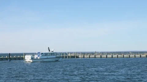 Boat leaving the docks on the ocean during the summer Stock Footage 76591549