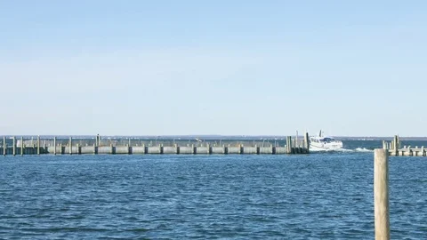 Boat leaving the harbor during a bright summer day Stock Footage 76591644