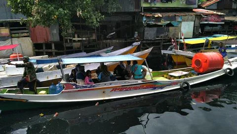 Boat loading passengers down the canal Stock Photos