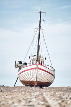 Boat lying on the beach Stock Photos