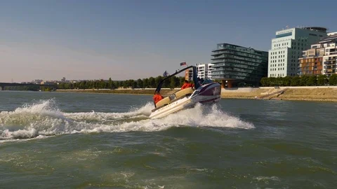 Boat making u turn on a river with background of a city, Stock Footage 120533081