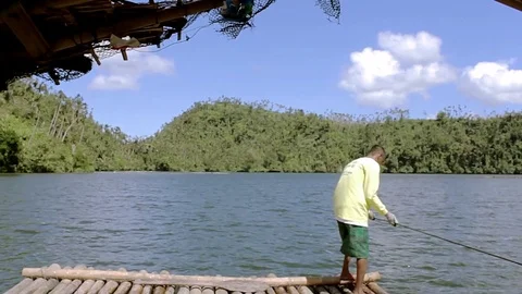 Boat man in lake pulling forward Vídeo Stock 79276095