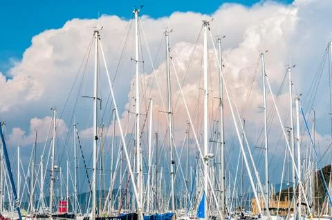 Boat masts on a background of thunderclouds Stock Photos