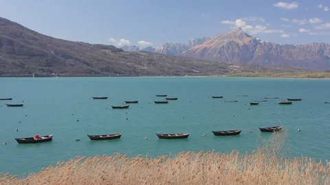 Boat mooring and cane thicket on Santa Croce Lake, Alpago Stock Footage 77757488