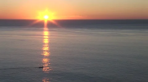 Boat Moves Through Sun Ray At Sunrise Stock Footage 1014637