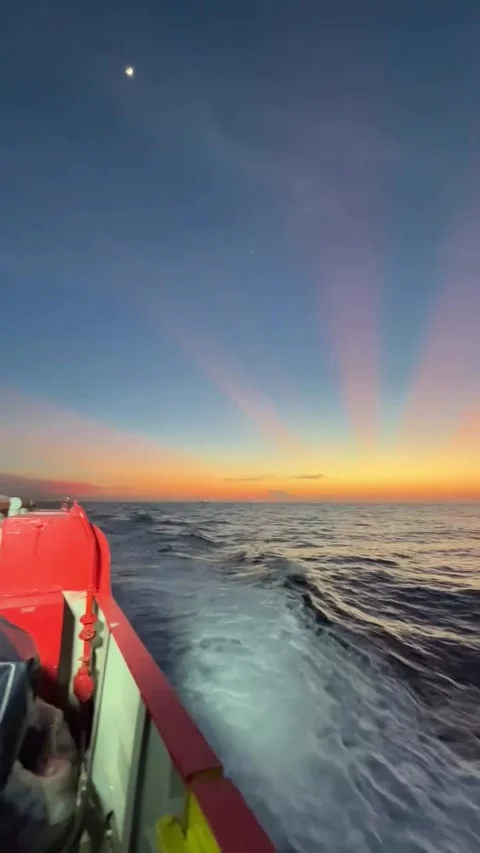 Boat Moving Across Ocean During Vibrant Sunset Stock Footage 341320500