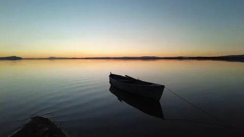 Boat moving with calm waves at sunset. Stock Footage 219145580