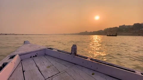 Boat moving during sunset or sunrise in the Ganga river at Varanasi Ghat Stock Footage 169332124