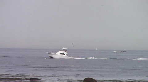 Boat moving fast, rocks in foreground Video stock 39909702