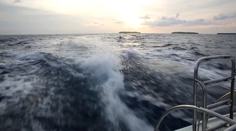 Boat moving fast at sunset in Pacific Ocean in Maldives leaving foam trail. 動画素材 59675840