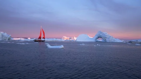 Boat moving towards iceberg with natural arch - Disko Bay, Greenland Stock Footage 115722574