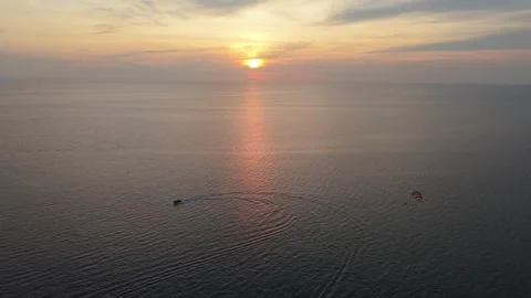 Boat navigates ocean waters at sunset, creating ripples and reflections Stock-Footage 342331354