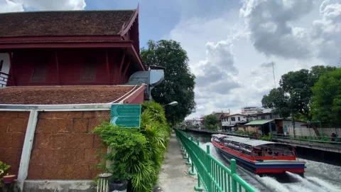 Boat navigates through a canal next to Jim Thompson Museum, Bangkok, Thailand 4K Stock-Footage 282640262