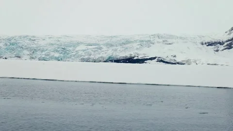 Boat Navigating Arctic Sea Ice Near a Glacier in Svalbard Stock Footage 339277644